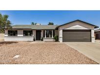 Charming single-story home featuring a desert landscape, a two-car garage, and a welcoming front entrance at 2124 E Boston St, Chandler, AZ 85225