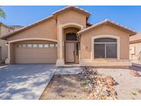 Inviting single-story home with a low maintenance front yard and a two car garage in Arizona at 23676 W Parkway Dr, Buckeye, AZ 85326
