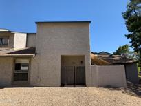 Two-story home featuring a gated front patio and desert landscaping at 244 E Ponderosa Ln, Phoenix, AZ 85022