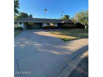 Charming single-story home with a spacious driveway and well-maintained front yard at 3144 N 84Th Pl, Scottsdale, AZ 85251