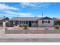 Charming single-story home with desert landscaping and stylish gray paint scheme at 3607 N 79Th Ave, Phoenix, AZ 85033