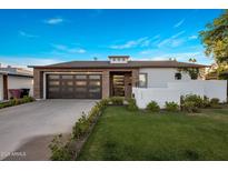 Beautiful home with a modern design, featuring a multi-car garage and well-maintained landscaping at 3626 N Mohave Way, Scottsdale, AZ 85251