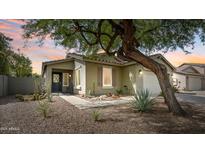 Charming single-story home featuring desert landscaping, a stone pathway, and a cozy covered porch at 4073 E Stable Ct, Gilbert, AZ 85297