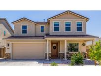 Charming two-story home featuring a welcoming front porch and a two car garage at 4283 W Nora Dr, San Tan Valley, AZ 85144