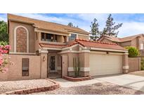 Two-story home featuring a red tile roof, stucco exterior, and well-kept landscaping at 529 E Taro Ln, Phoenix, AZ 85024