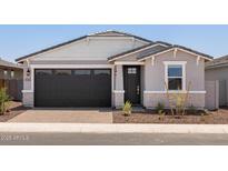Charming single-story home featuring a dark garage door and decorative stone accents at 5549 S 246Th Ave, Buckeye, AZ 85326