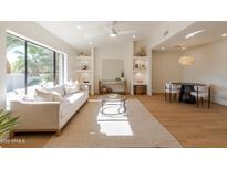 Bright living room featuring a large window, stylish decor, and an open floor plan with light wood flooring at 7127 N 79Th St, Scottsdale, AZ 85258