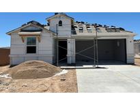New construction home with attached two car garage with partial roof and exterior frame at 7369 W Buckhorn Trl, Peoria, AZ 85383