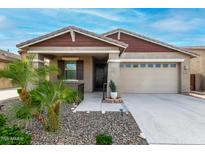 Inviting single-story home featuring a landscaped front yard and two car garage at 7618 S Lone Pine Pl, Gold Canyon, AZ 85118