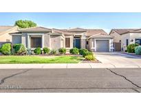 Beautiful single-story home featuring desert landscaping, a three car garage, and inviting front entrance at 853 E Ivanhoe Ct, Gilbert, AZ 85295
