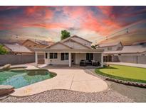 Outdoor oasis featuring a private pool, putting green, and covered patio with stylish furniture at 910 S Crossbow Ct, Chandler, AZ 85225