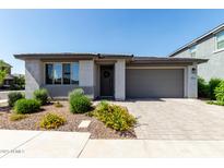 Charming single-story home featuring a two-car garage and beautifully landscaped front yard at 9312 E Spiral Ave, Mesa, AZ 85212