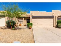 Charming single-story home with a two-car garage, desert landscaping and a cozy front entrance at 10863 N 117Th Pl, Scottsdale, AZ 85259
