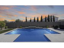 Backyard pool with waterfall feature and artificial grass, great for outdoor entertaining at 13171 W Redstone Dr, Peoria, AZ 85383