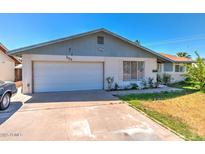 Charming single-story home featuring a two-car garage and quaint landscaping at 133 W Balboa Dr, Tempe, AZ 85282