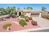 Charming single-story home with a well-manicured, colorful desert landscape and a two-car garage at 13444 W Cabrillo Dr, Sun City West, AZ 85375