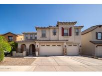 Charming two-story home with a three-car garage and well-manicured front yard in a quiet neighborhood at 18401 W Westfall Way, Surprise, AZ 85374