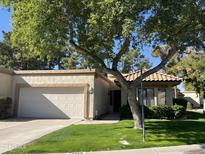 Charming single-story home with well-maintained landscaping and attached garage at 19014 N 91St Dr, Peoria, AZ 85382