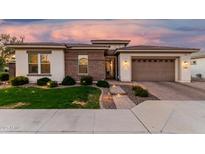 Charming home featuring manicured lawn, beautiful brick accents, and a lovely paver driveway leading to a two-car garage at 2052 E Scorpio Pl, Chandler, AZ 85249