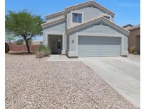 Charming two-story home with a well-maintained front yard and attached two-car garage at 21754 W Pima St, Buckeye, AZ 85326