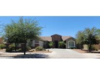 Charming single-story home with a desert landscape, neutral exterior, and a welcoming entrance at 21985 E Quintero Rd, Queen Creek, AZ 85142