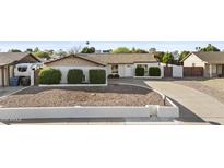 Charming single-story home featuring a well-maintained yard with mature landscaping at 3754 W Hearn Rd, Phoenix, AZ 85053