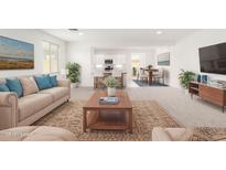 Bright and airy living room with a modern design that opens to the dining and kitchen areas at 3815 S 64Th Ln, Phoenix, AZ 85043