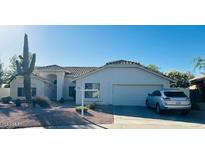 Charming single-story home with desert landscaping and a two-car garage at 4102 E Rancho Tierra Dr, Cave Creek, AZ 85331