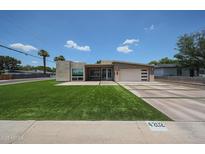 Stunning home with contemporary architecture, lush green lawn, and a modern driveway design at 4202 E Catalina Dr, Phoenix, AZ 85018