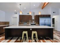 Bright kitchen features a large island with a breakfast bar, stainless steel appliances, and modern cabinets at 4202 E Catalina Dr, Phoenix, AZ 85018