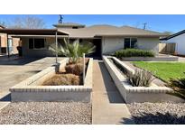 Charming single-story home with desert landscaping in the front yard at 4213 N Westview Dr, Phoenix, AZ 85015