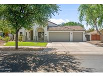 Charming single-story home with a three-car garage and a well-maintained front yard at 4455 E Marshall Ave, Gilbert, AZ 85297