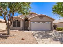 Charming single-story home with a two-car garage and well-maintained desert landscaping in front at 4911 E Holmes Ave, Mesa, AZ 85206