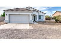 Charming single-story home with tile roof, two-car garage, and low maintenance front yard at 5230 E Pony Track Ln, San Tan Valley, AZ 85140