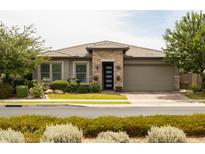 Charming single-story home featuring desert landscaping and a two-car garage at 5515 S Caisson Way, Mesa, AZ 85212