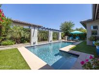Sparkling swimming pool with built-in fountains and pergola providing shade and elegance at 5515 S Caisson Way, Mesa, AZ 85212