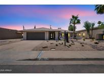 Charming single-story home with desert landscaping, two-car garage, and inviting entrance at 6620 E Paradise Ln, Scottsdale, AZ 85254