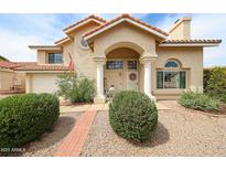 Charming two-story home featuring a tile roof, arched entry, and manicured front yard at 7110 N 28Th Dr, Phoenix, AZ 85051