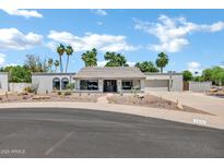 Single story home featuring desert landscaping, a tile roof, and a well-maintained front yard at 8936 N 80Th Pl, Scottsdale, AZ 85258