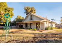 Charming single-story home with front yard, landscaping and unique decorative windmill at 937 E 6Th Ave, Mesa, AZ 85204