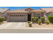 Charming single-story home featuring a two-car garage and meticulously maintained front yard at 9535 E Tupelo Ave, Mesa, AZ 85212