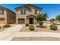Inviting two-story home featuring a well-maintained yard and a one car attached garage at 198 E Patton Ave, Coolidge, AZ 85128