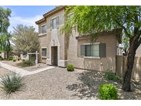 Charming two-story home featuring a front yard with low-maintenance desert landscaping at 21973 N 102Nd Ln # 411, Peoria, AZ 85383