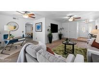 Inviting living room featuring stylish decor, wood floors, and a cozy seating area with ceiling fans at 2804 N Nebraska St, Chandler, AZ 85225