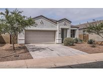 Charming single-story home featuring a two-car garage and desert landscaping at 30996 W Osborn Rd, Buckeye, AZ 85396