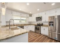 Updated kitchen with stainless steel appliances, granite counters and bright cabinets at 3441 E Taylor St, Phoenix, AZ 85008