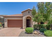 Charming front exterior featuring a tile roof, paver driveway, and meticulously landscaped yard at 3886 E Ficus Way, Gilbert, AZ 85298