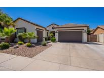 Charming single-story home featuring a three-car garage, desert landscaping, and a neutral color palette at 3971 E Leo Pl, Chandler, AZ 85249