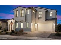 Gorgeous two-story home boasts a brick driveway, attached two-car garage, and immaculate landscaping at 5661 S Dante --, Mesa, AZ 85212