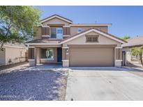 Two-story home with a two-car garage, neutral color palette, and low-maintenance landscaping, exemplifying suburban charm at 763 E Maddison St, San Tan Valley, AZ 85140